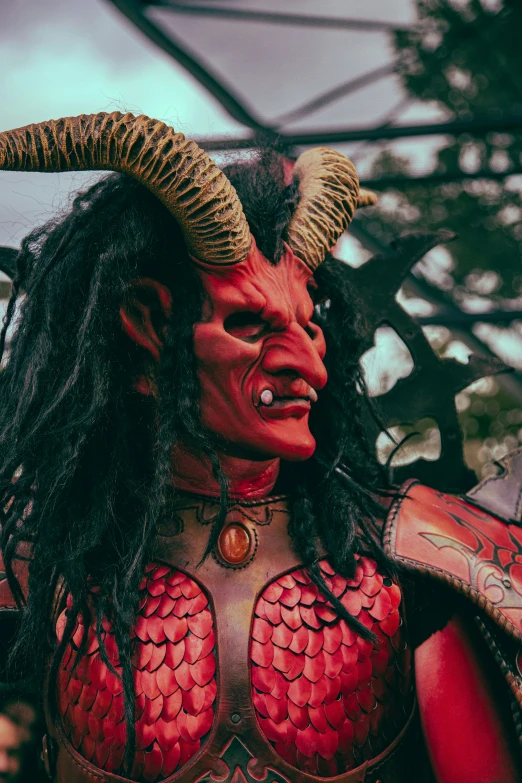 a woman wearing a red mask and horns