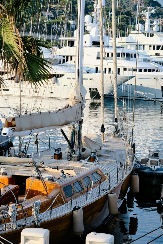 many sailboats in the water with a dock