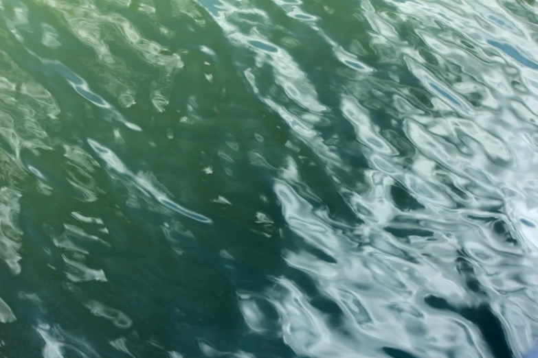 green water reflected by bright sunlight shining through the reflections on it