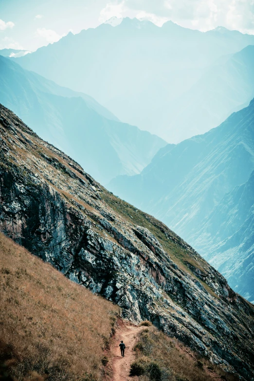 the sky over a hill covered in mountains