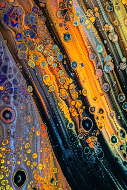 drops of oil sitting on top of liquid on a table