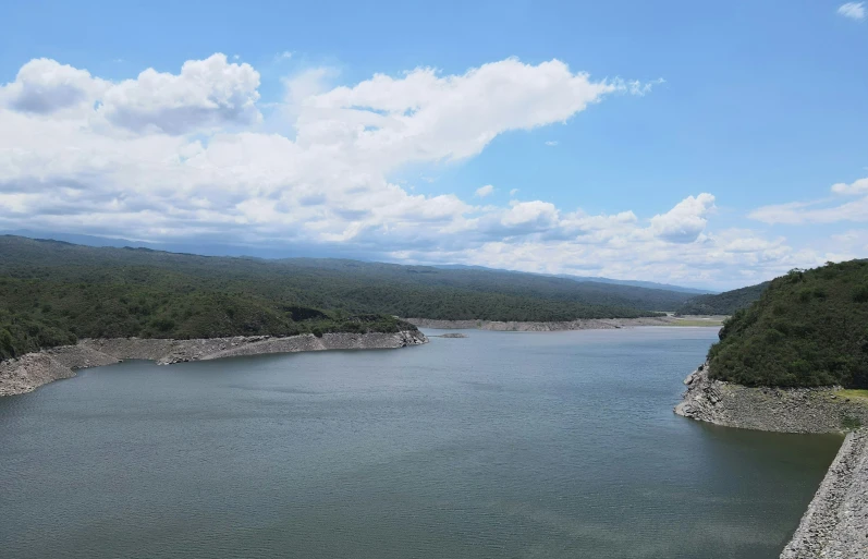 the view of a reservoir and mountains from a hill