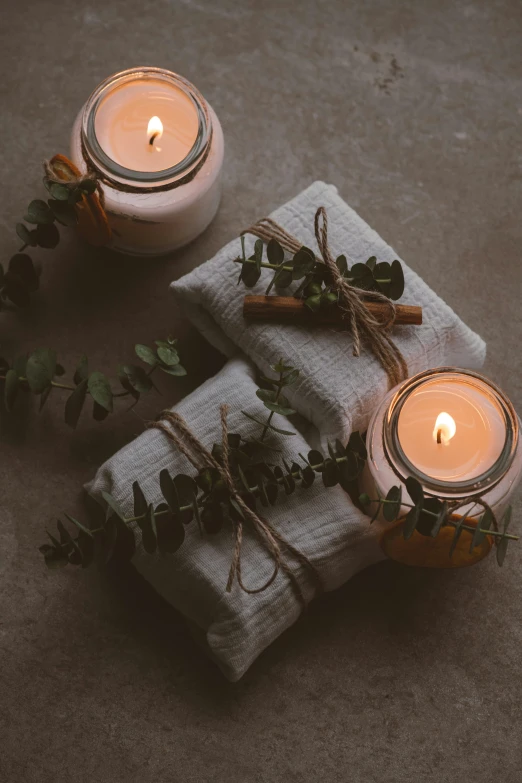 two wrapped candles on top of two napkins