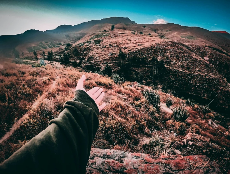 a persons'foot standing on the edge of a mountain