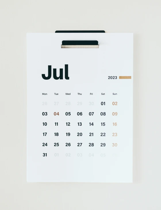 a calendar pinned on a piece of paper with a clip