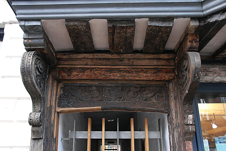 the front porch of an old building with wood framing