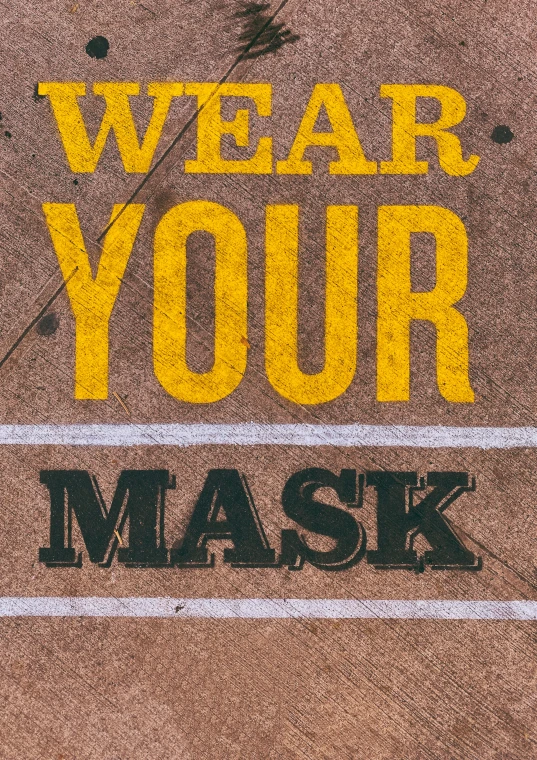 there is a yellow and black message next to a mask