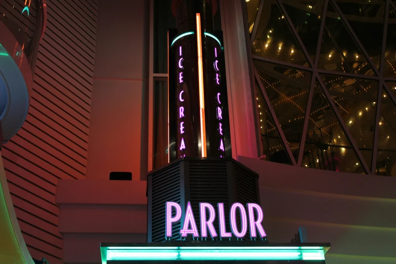 the name parlor in neon lights on a building