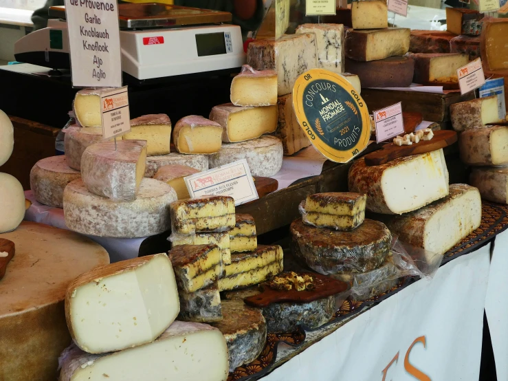 different types of cheese sitting on top of a table