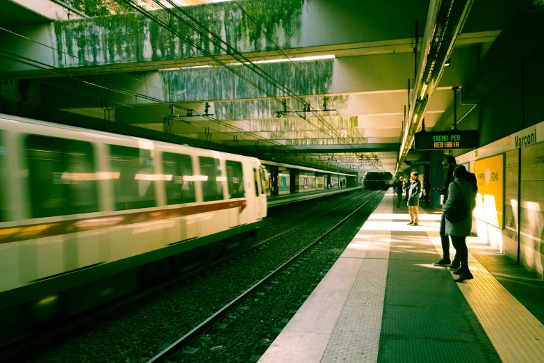 a man is walking by a long train as it comes towards him