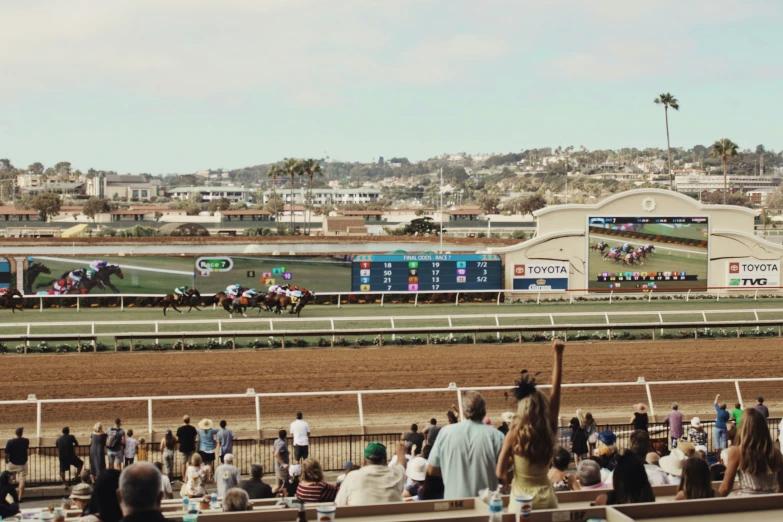 the jockeys are watching the horses race on the track