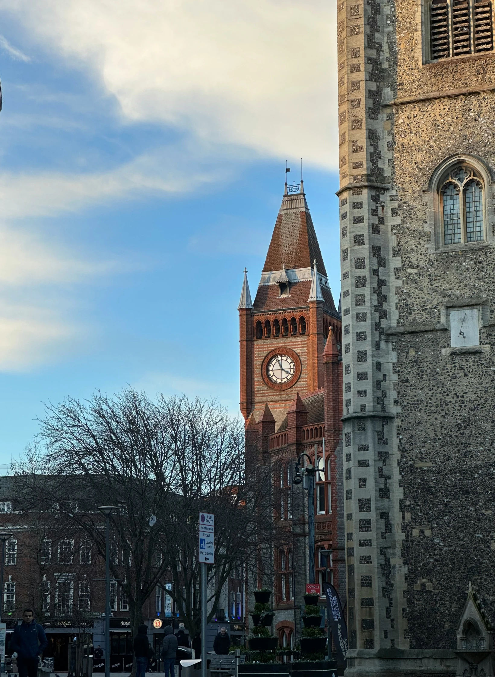 an old building is next to another tall clock tower