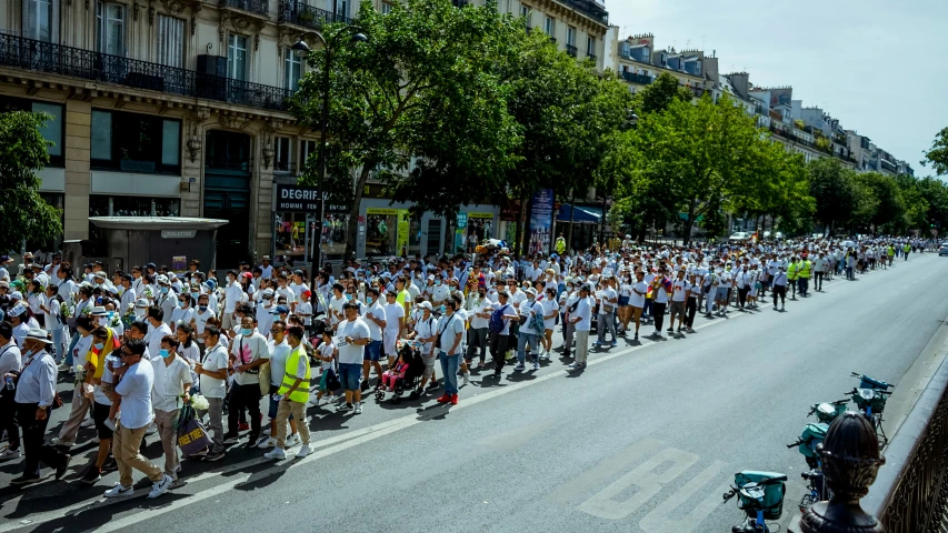 a long line of people with white shirts