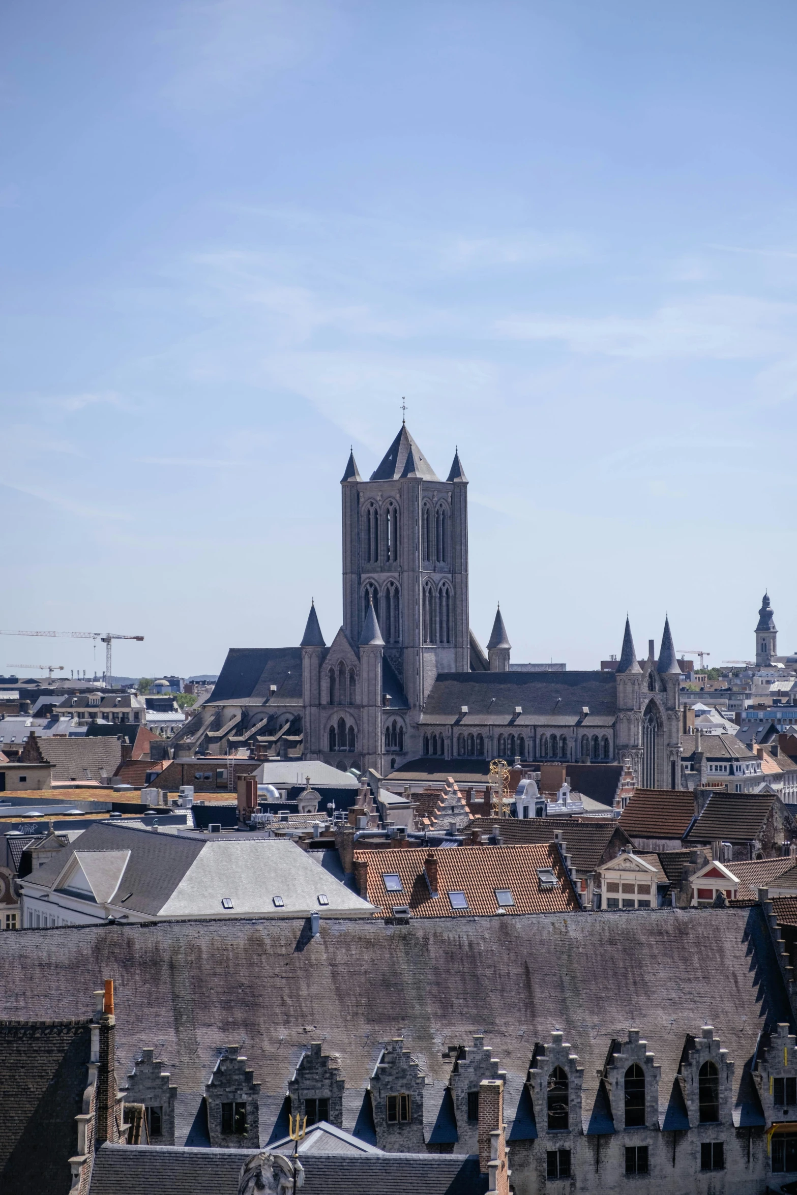 a view of a cathedral tower over the city of saint - laurent in france