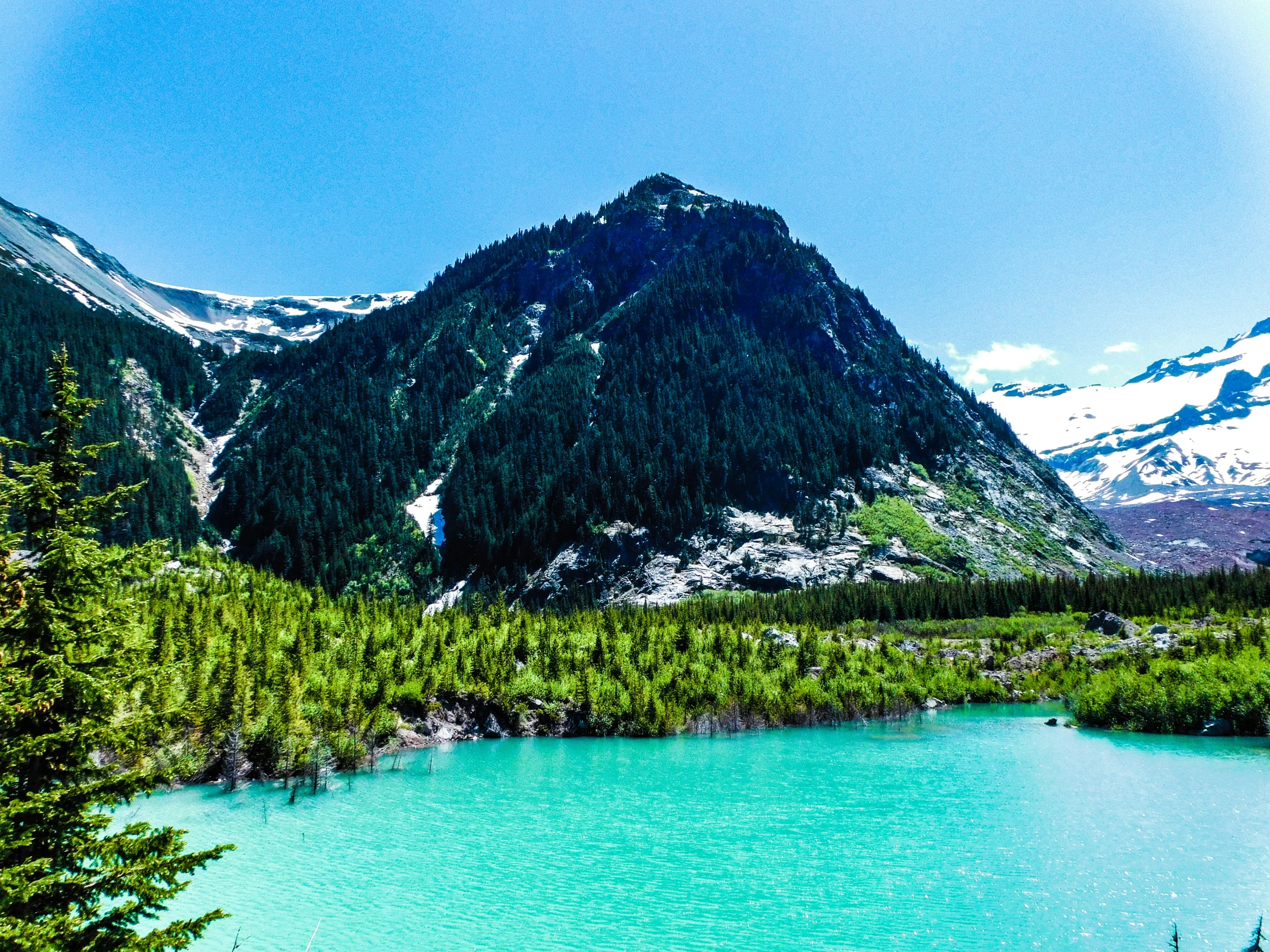 the mountain is shown with a bright blue river