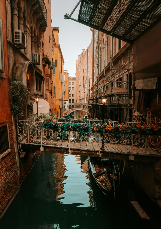 there is a small boat that has parked near an area that looks very narrow and crowded