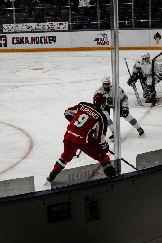 three hockey players on the ice playing a game