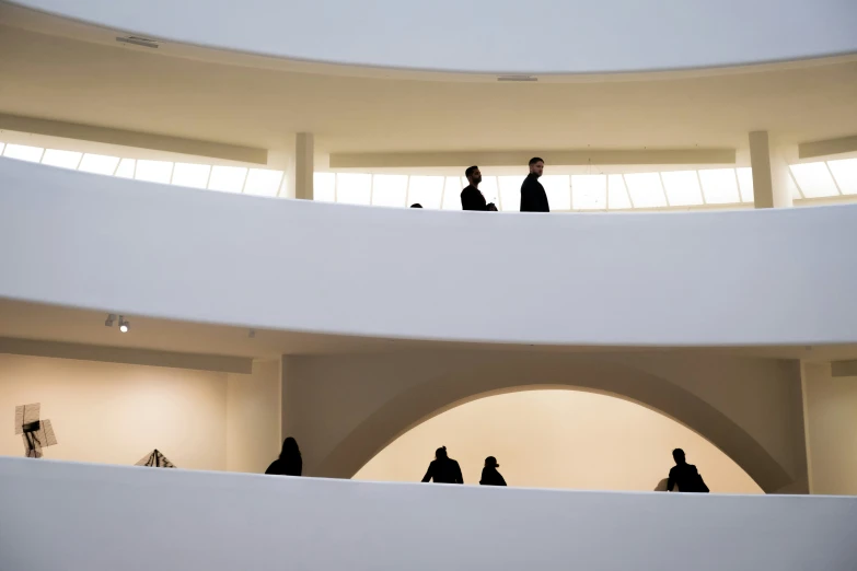 a group of people walking down a spiral walkway