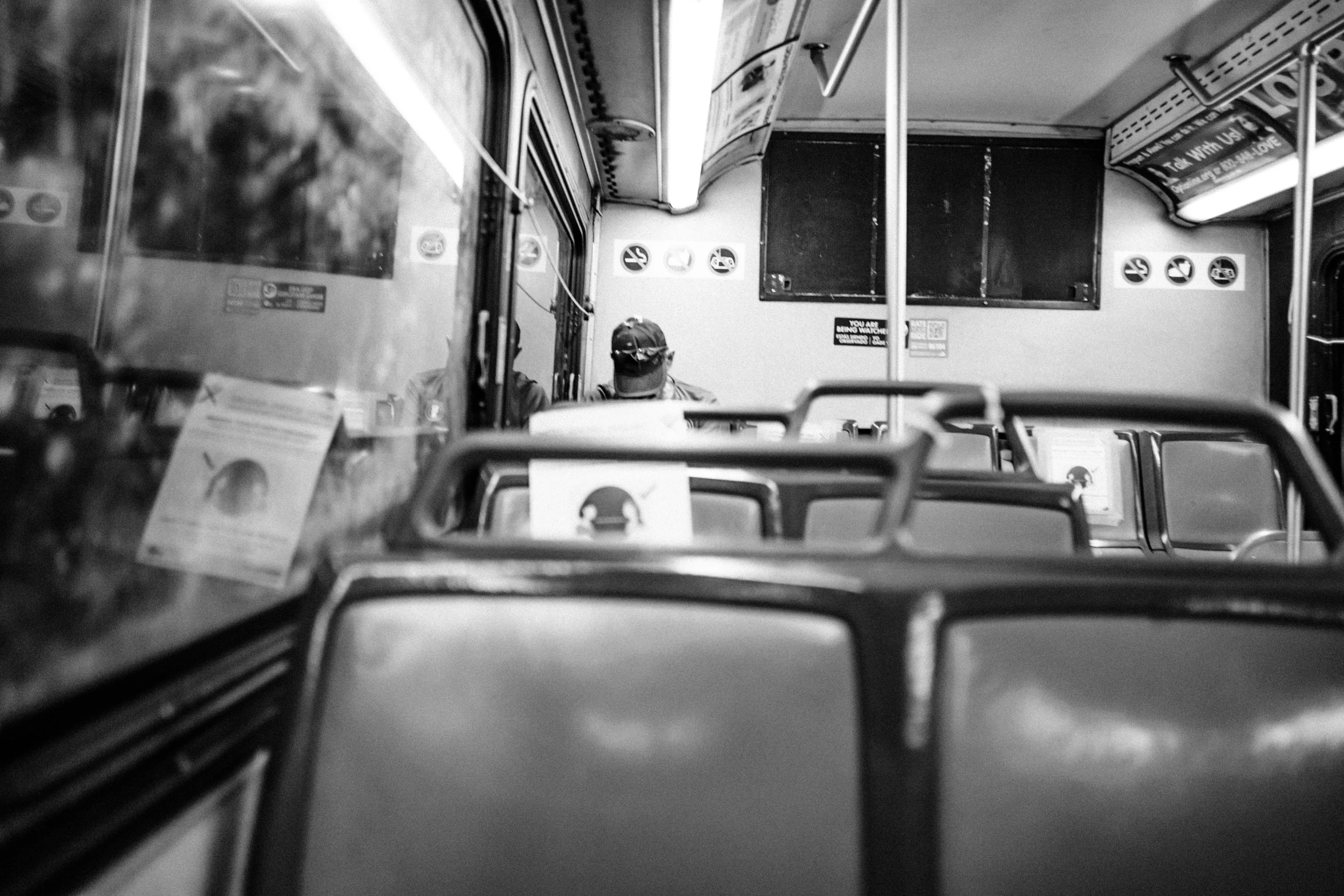 rows of empty seats in a bus on a rainy day