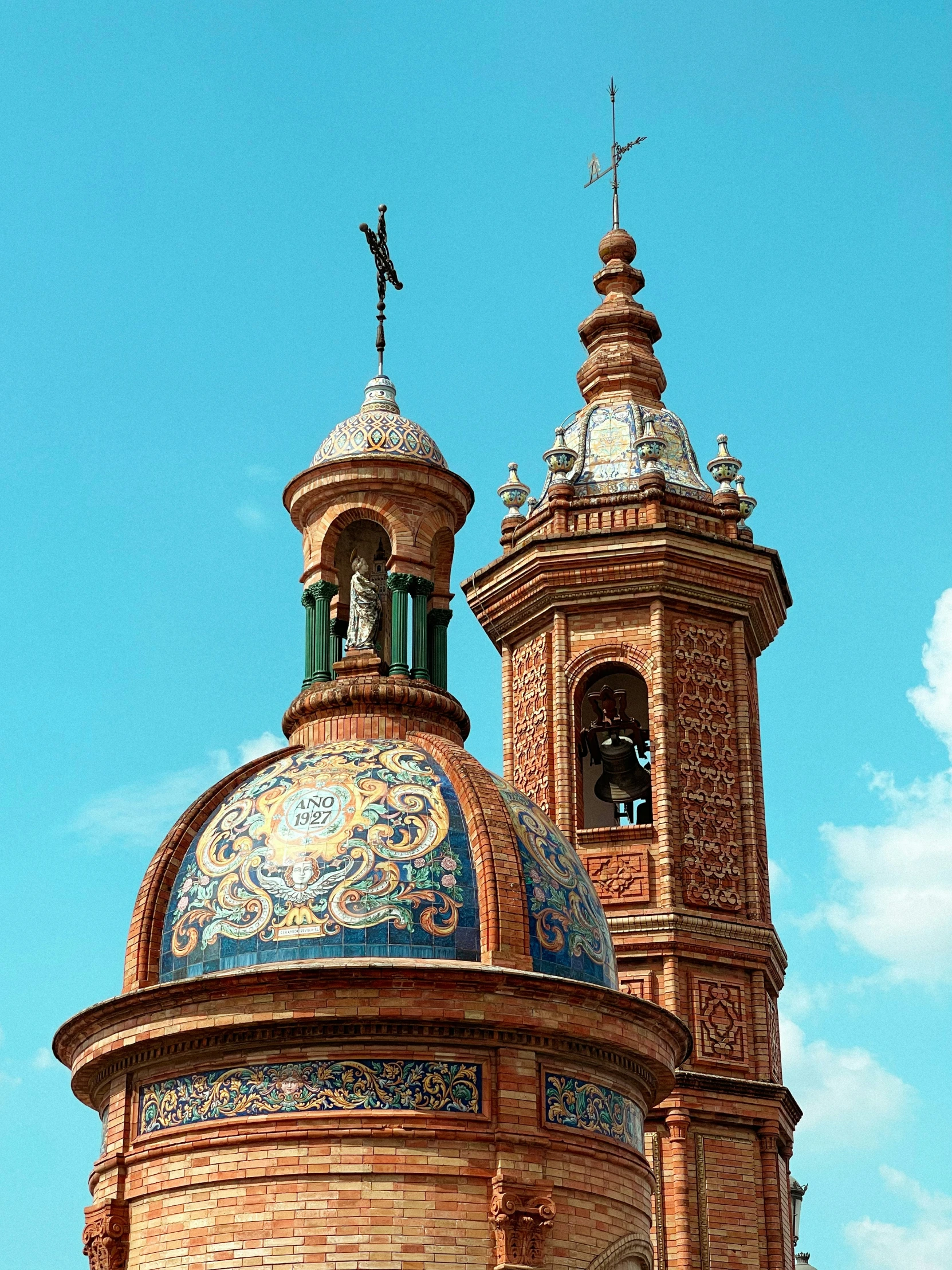 the bell tower has a green cupola above it