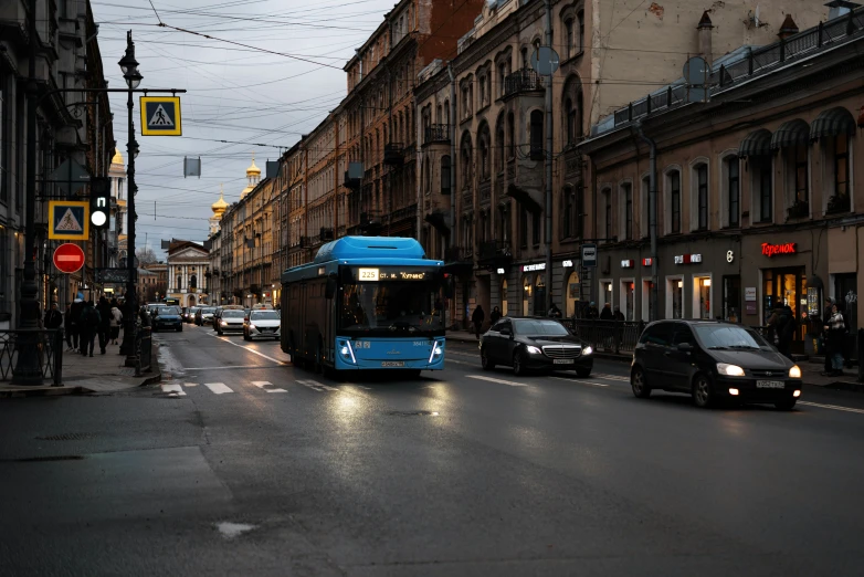 the bus rides down the road as traffic passes by