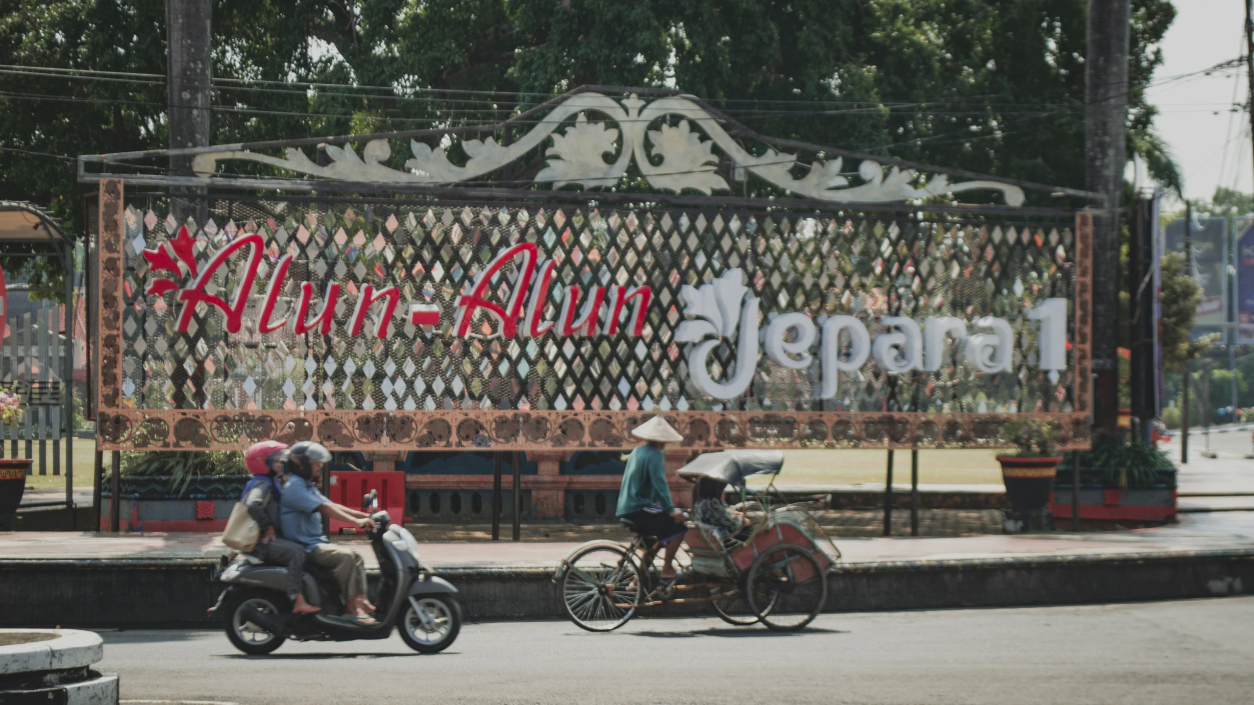 two people with hats on are riding their motorbikes in front of an advertising sign