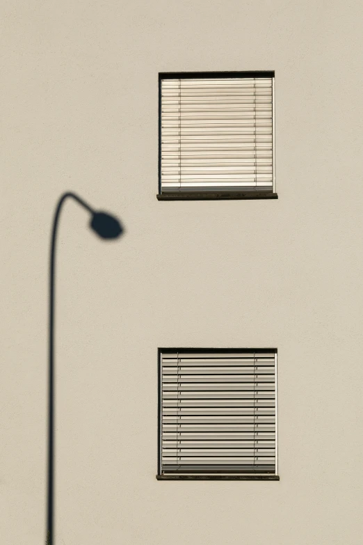 a street light and a window on a stucco building