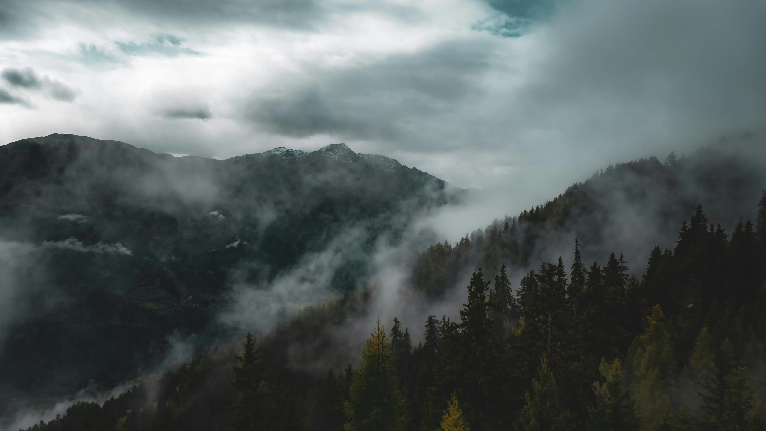 a mountain covered in fog and mist