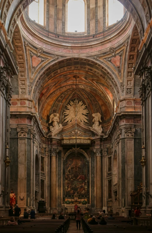 the inside of an old cathedral with a lot of pews