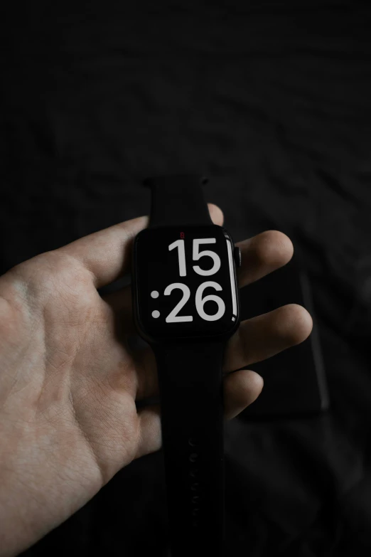 a close up of a person's hand holding an electronic watch