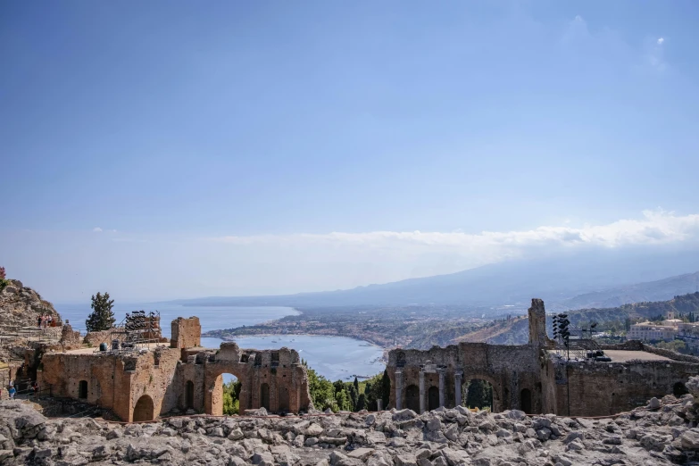 a view of the city and water from an old roman building