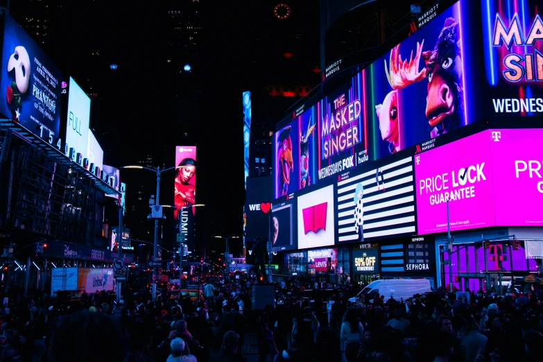 several large, colorful, lighted billboards show bright city lights