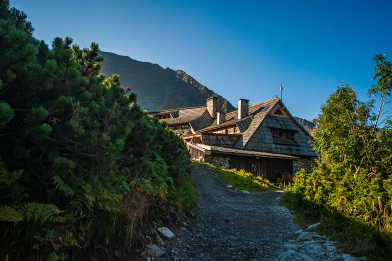 an old cottage has a long pathway leading to it