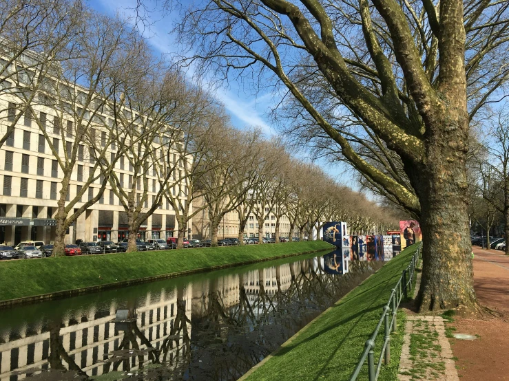 the view of some buildings across the street, along a canal