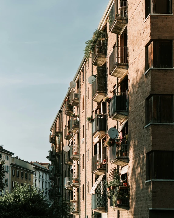 an apartment building with balconies on it's windows and balconies down the street