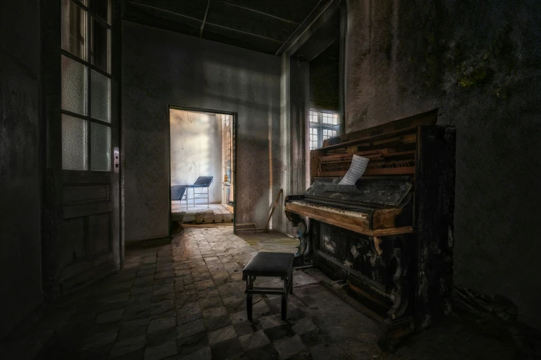 a very dark room with a piano and a rocking chair