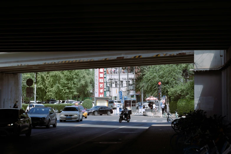 people are sitting and walking on a street with cars