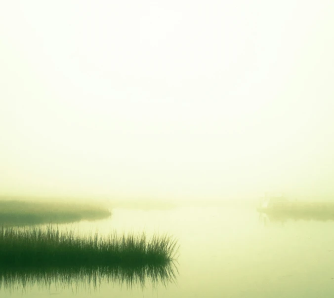 two boats on a foggy waterway in the middle of nowhere