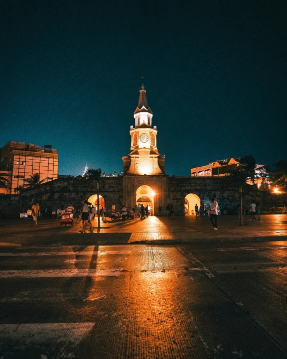 a clock tower stands in the center of a large city