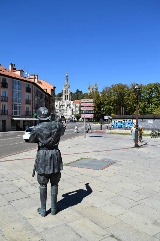 a statue of a man holding a book on a square