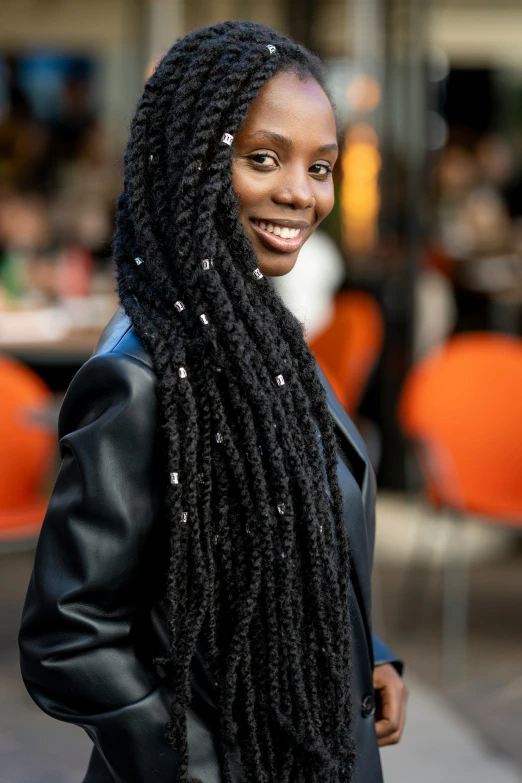 a smiling woman with very long dreadlocks