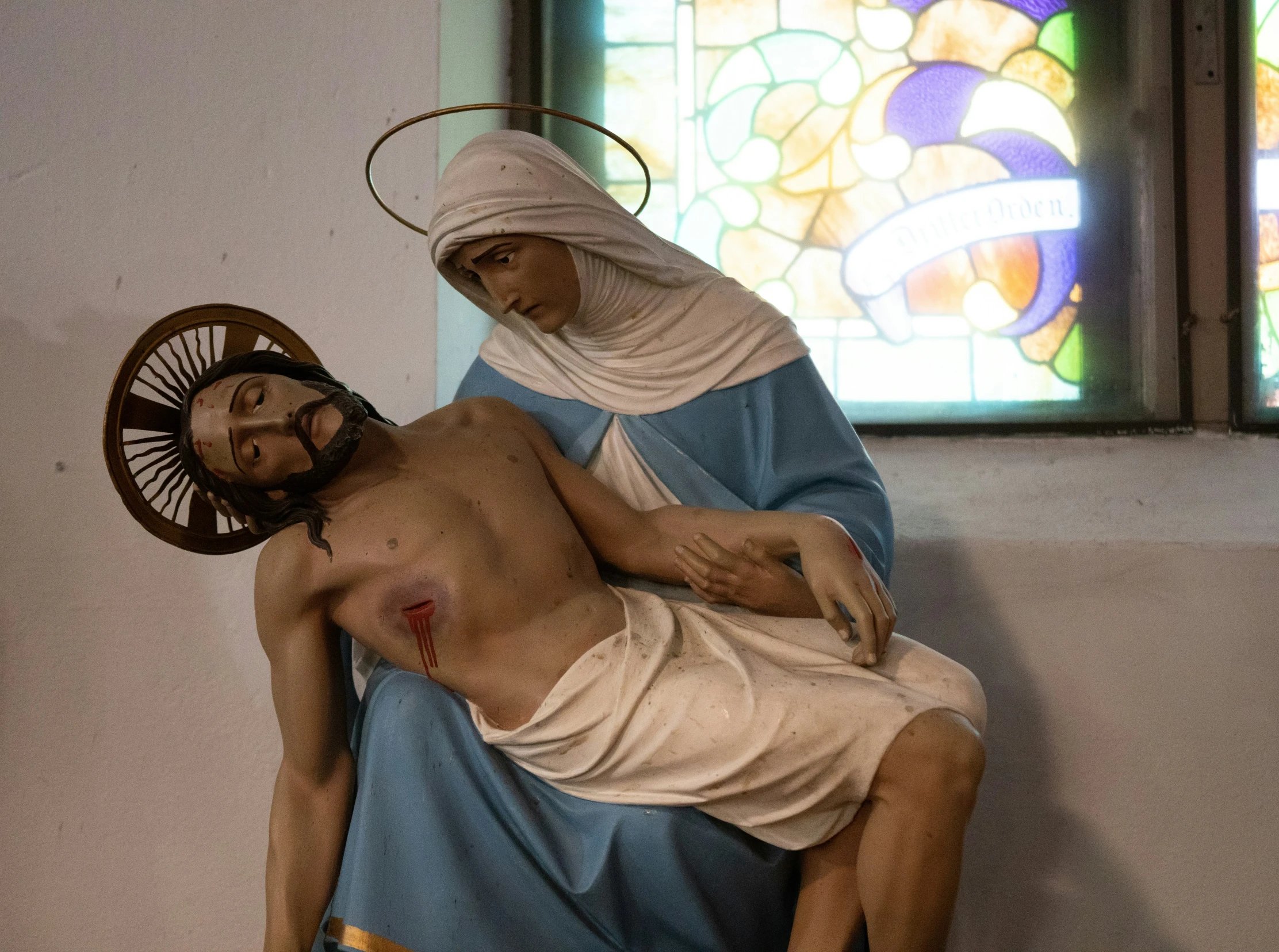 a statue of the mother and child inside of a church