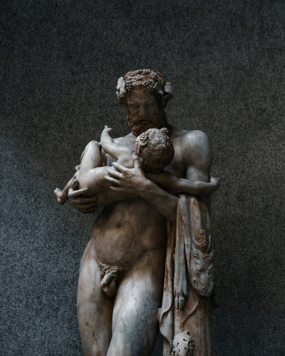 a large statue of a man holding a child