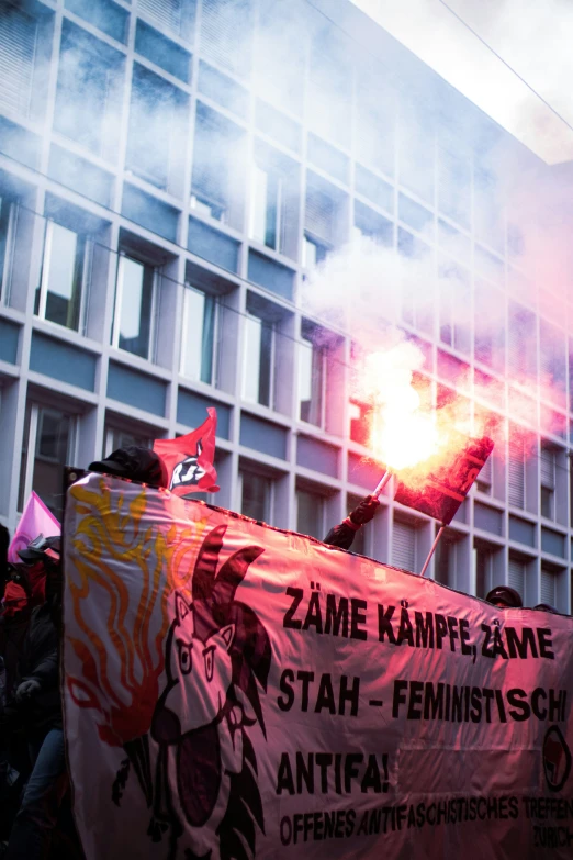 there are people standing in front of some building holding a sign