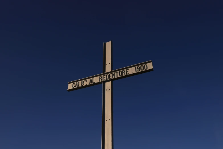 a tall metal street sign next to a pole