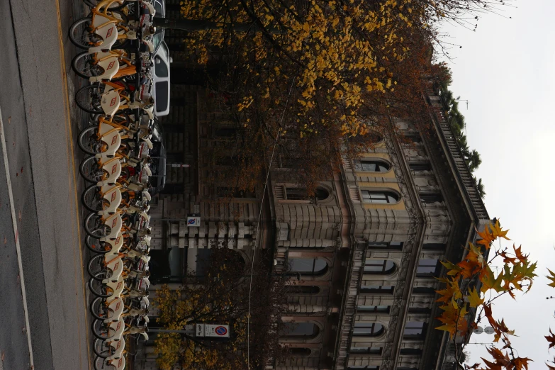 several tables lined up along the side of a building