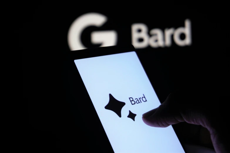 someone holding an open cell phone showing a bard sign