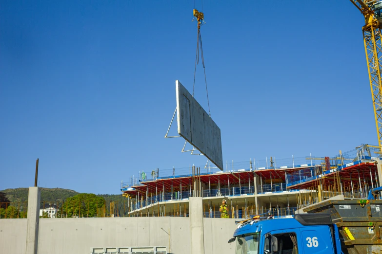 a blue truck is parked in front of the large building