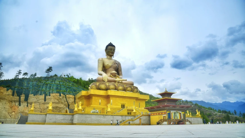 the buddha statue stands on top of the small staircase