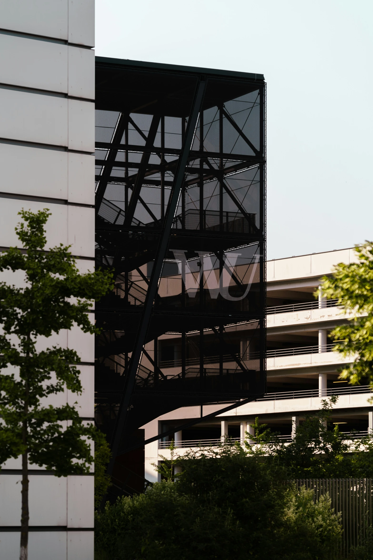 a black and white building a white and black clock and some trees